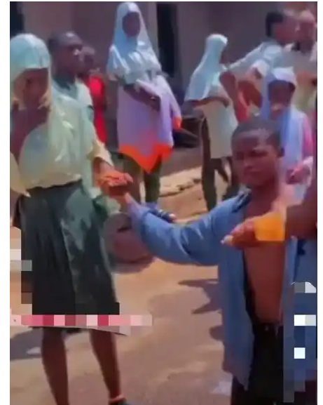 Secondary school student goes on one knee, proposes to his girlfriend at end of WAEC exams (video)