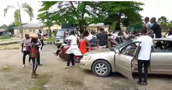 The scary moment a final year NDU student rammed into a group of students with his car (video)