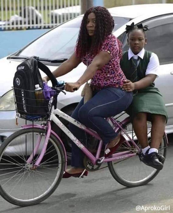 Okada Ban: Woman Takes Her Daughter To School By Bicycle